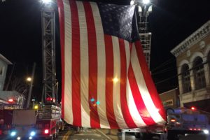 A large American flag hangs outside the Capitol Theatre, which caused part of Westchester Avenue to be closed off by Port Chester firetrucks and police vehicles. The venue held a benefit concert to honor slain NYPD Det. Joseph Lemm, of West Harrison, who was killed in action in Afghanistan. Photo courtesy Christian Arango