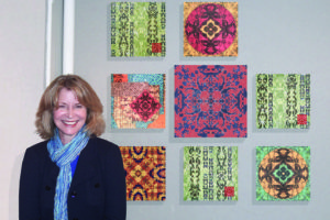Artist Heidi Lewis Coleman with her eight panel assemblage. Contributed photo