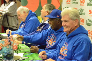Members of the 1969 Mets, from left, Ed Kranepool, Ron Swoboda, Cleon Jones and Duffy Dyer, sign memorabilia for fans on March 25 at Stew Leonard’s in Yonkers. The Miracle Mets and Stew Leonard’s are celebrating their 50th anniversaries this year.