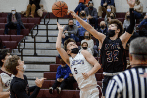 Sebastian Medina blocks a shot by Alex Rosenstock on Jan. 21, 2022. The Garnets topped the Huskies 58-43.