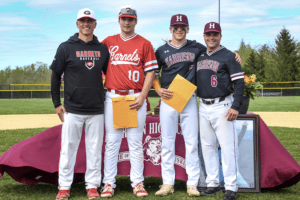 Jackson Fowle and Cal McCarthy pose with their coaches after winning the Andrew Gurgitano Memorial Scholarship Awards in a pregame ceremony. The award is given out each year to two senior players that best embody Gurgitano’s spirit and passion for the game.
