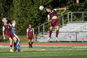 Braiden Sottile heads the ball against Mahopac on Sept. 12, 2022. Sottile had Harrison’s goal in a 2-1 loss.