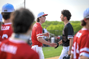 Shep Griffiths and Luke Burden shake hands following a game between the Huskies and Garnets on May 9.