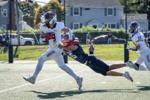 Jason Crupi sheds a tackle en route to a touchdown against Eastchester on Sept. 20. The Huskies topped the Eagles 28-22.
